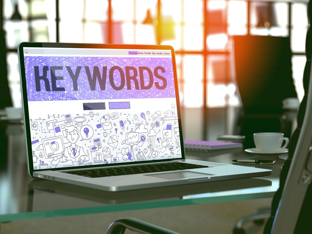 Keywords - Closeup Landing Page in Doodle Design Style on Laptop Screen. On Background of Comfortable Working Place in Modern Office. Toned, Blurred Image. 3D Render.